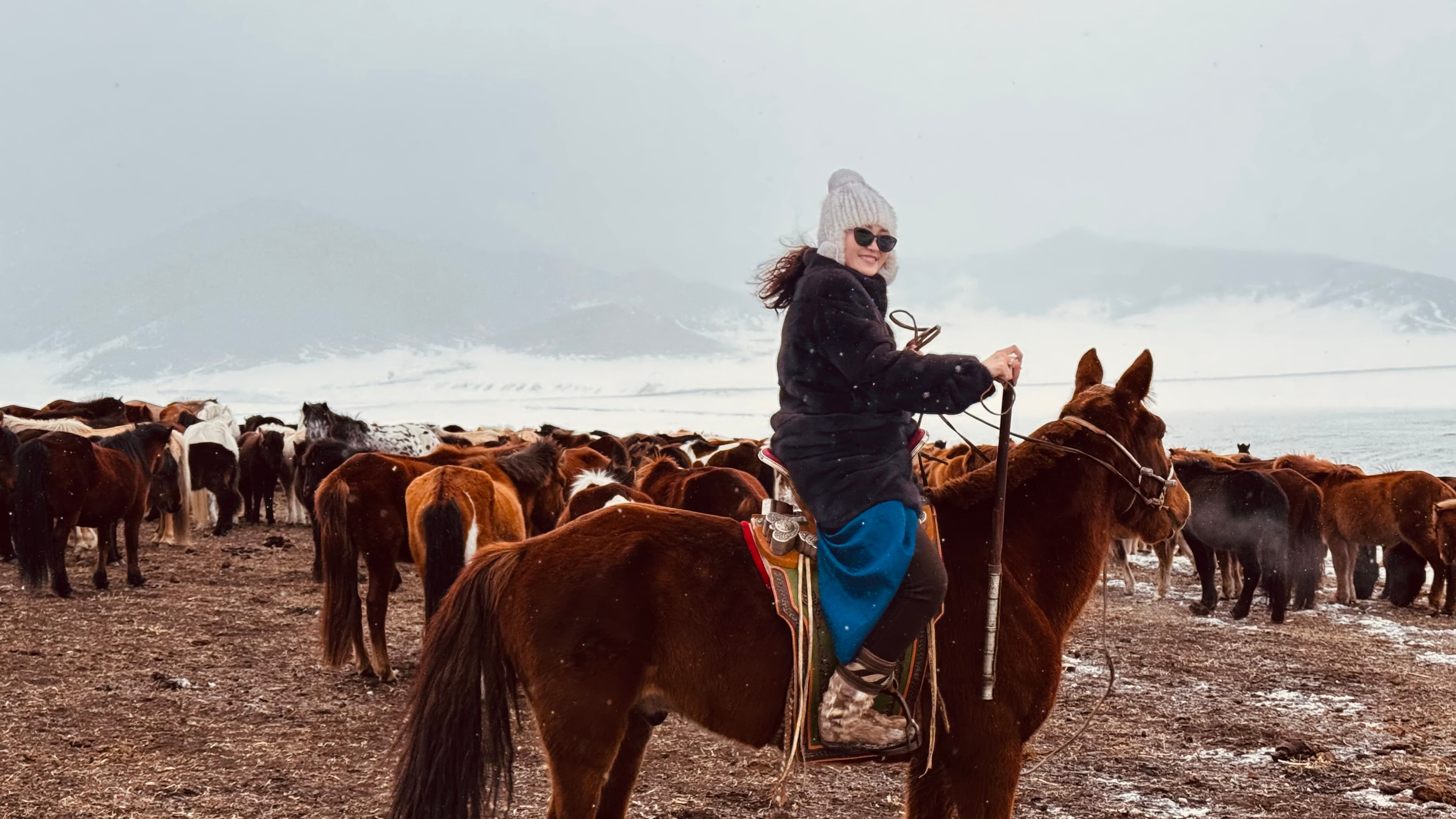 Mongolian nomadic family on horseback in the steppe
